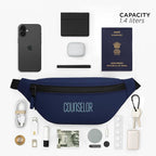 Navy Nexo waist pouch with capacity label, surrounded by essentials like phone, passport, wallet, and keys.