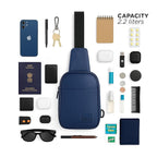 The Kiro Crossbody Bag in navy with organized essentials, showcasing its 2.2 liter capacity and stylish eco-friendly design.