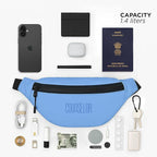 Sky blue Nexo waist pouch with 1.4L capacity, surrounded by essential items like phone, passport, and wallet.