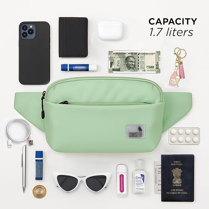 The Avelin waistpack in pista green with smartphone, wallet, and essentials on flat surface.