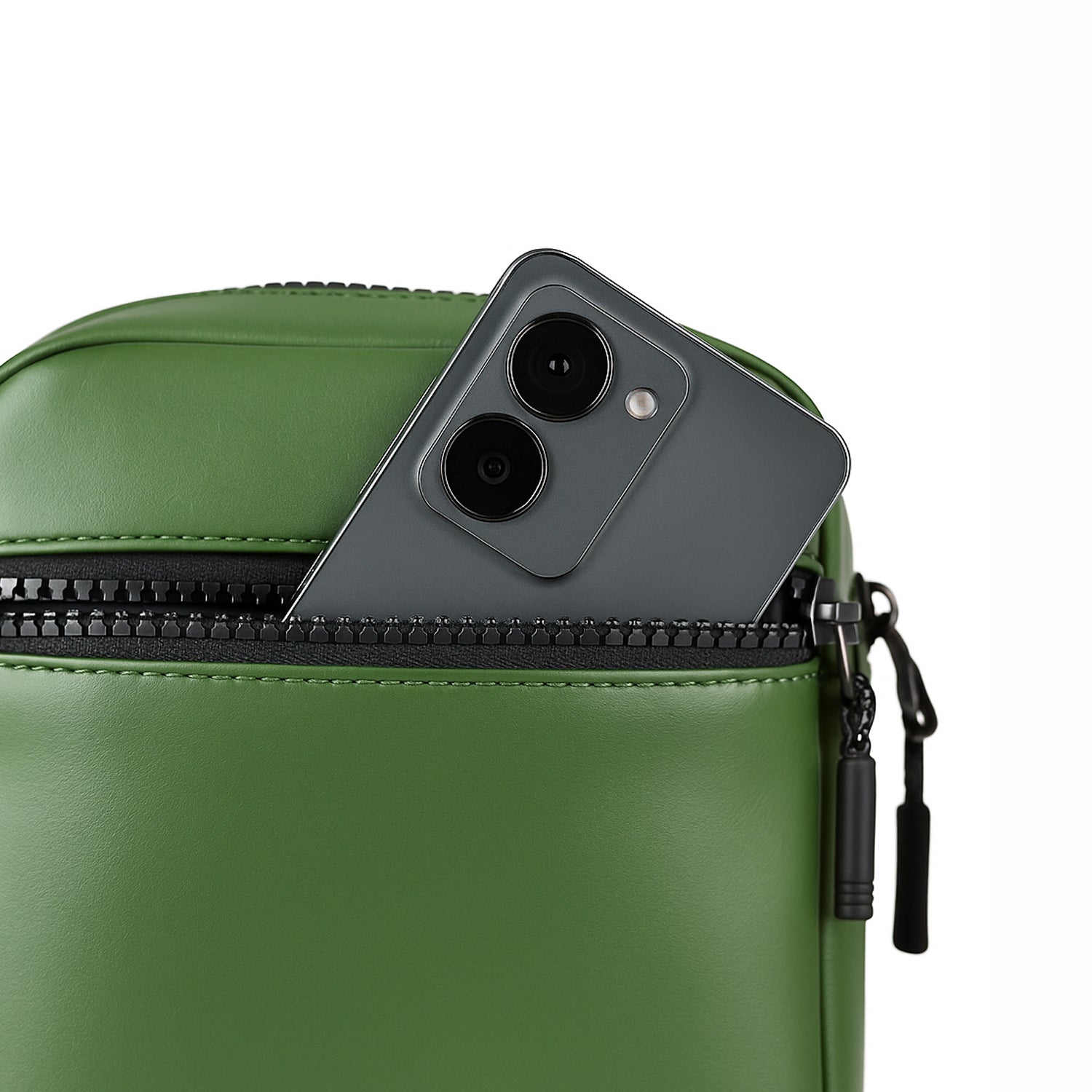 Green bag with a smartphone partially visible in its front zipper pocket, showcasing stylish and functional design.