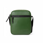 Stylish green crossbody bag made from vegan leather with adjustable strap and front zipper pocket.