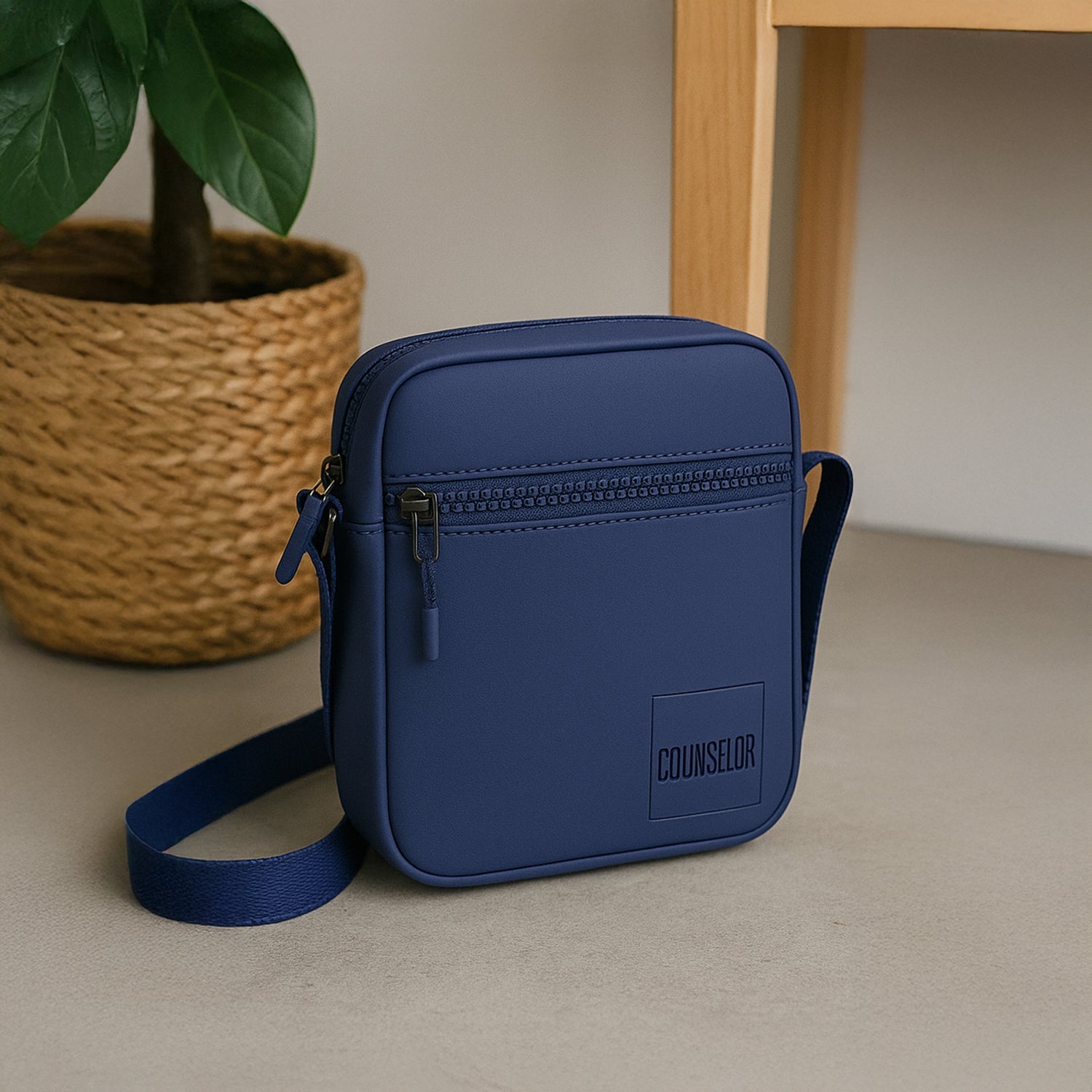 Stylish navy crossbody bag with zipper pocket and adjustable strap, perfect for daily use and travel.