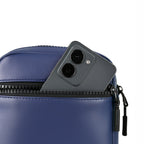 Close-up of a navy bag with a smartphone partially visible in the zipper pocket, showcasing efficient organization.