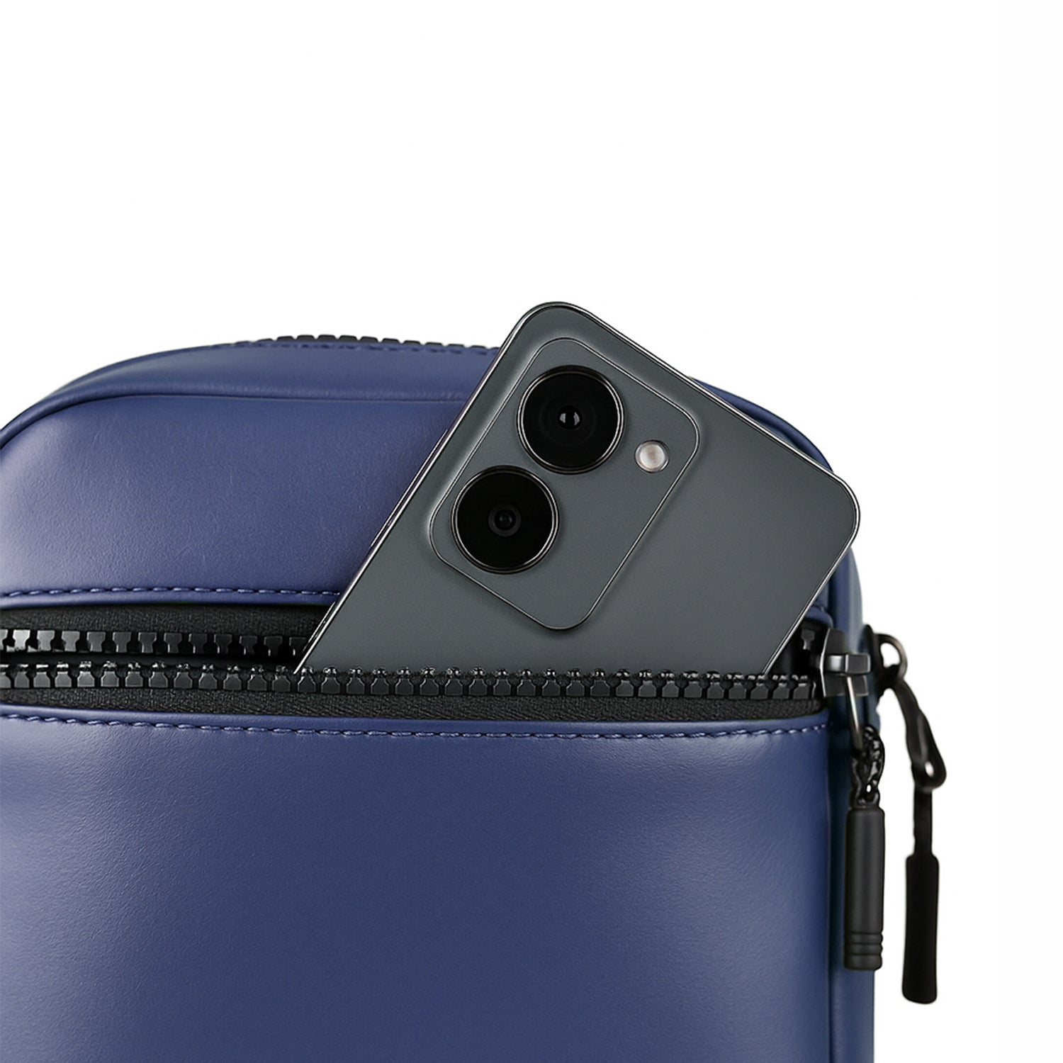 Close-up of a navy bag with a smartphone partially visible in the zipper pocket, showcasing efficient organization.