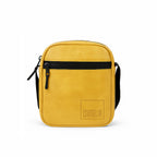 Stylish mustard yellow vegan leather sling bag with a front zipper pocket and adjustable strap.