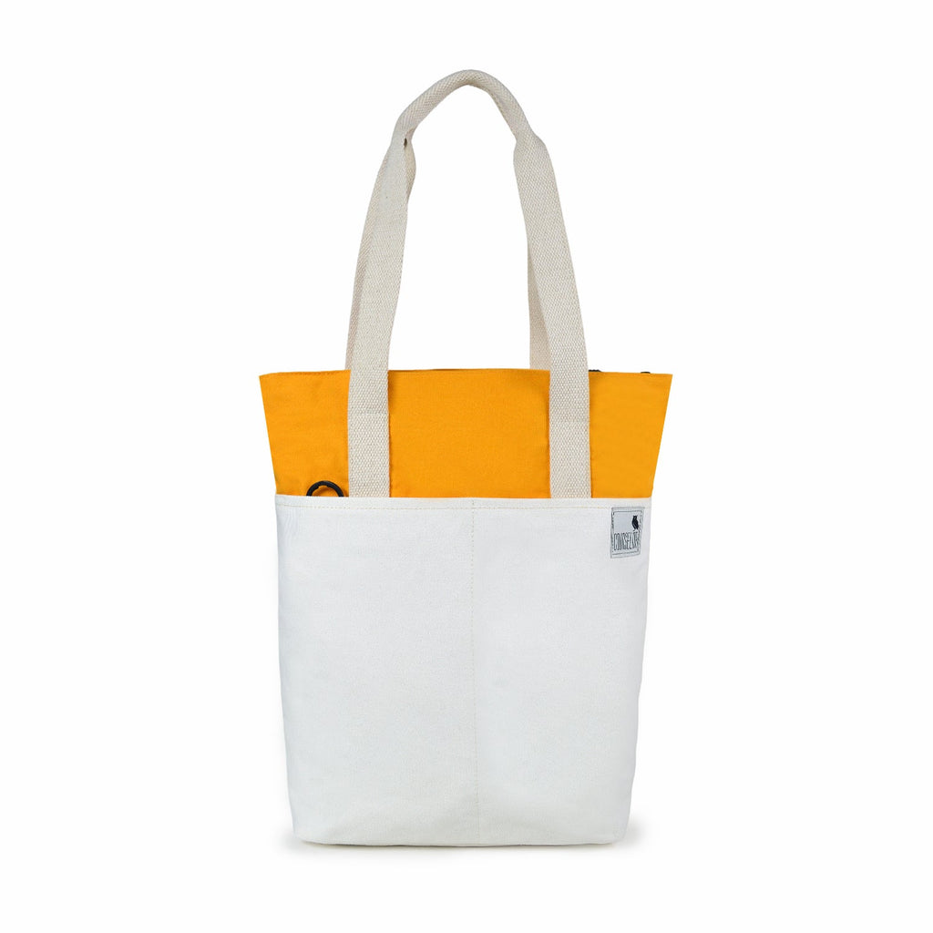 The Skylin off-white and yellow canvas tote bag with dual handles, stylish design, and practical compartments.