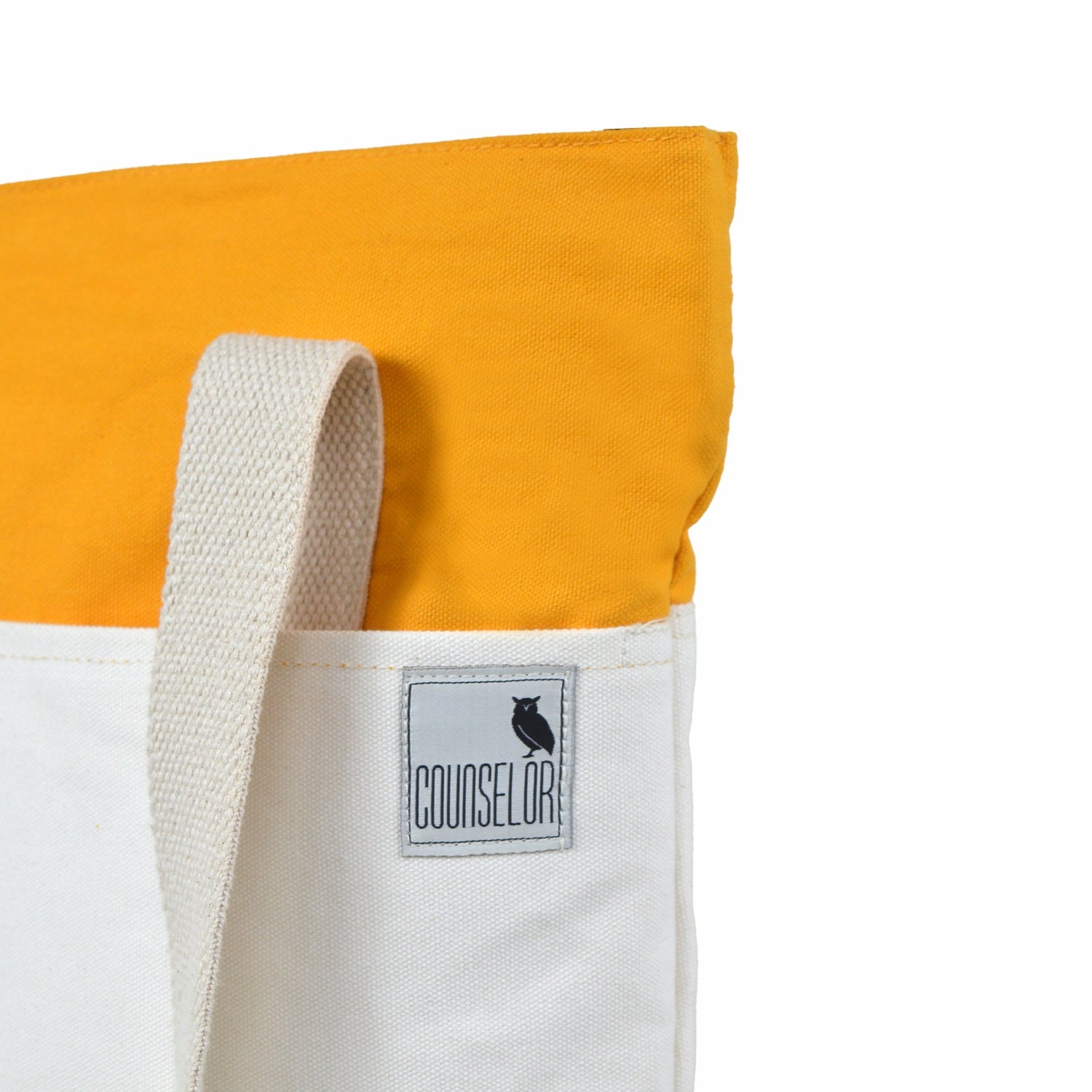 The Skylin tote bag in offwhite and yellow, featuring a minimalist design and sturdy shoulder strap.
