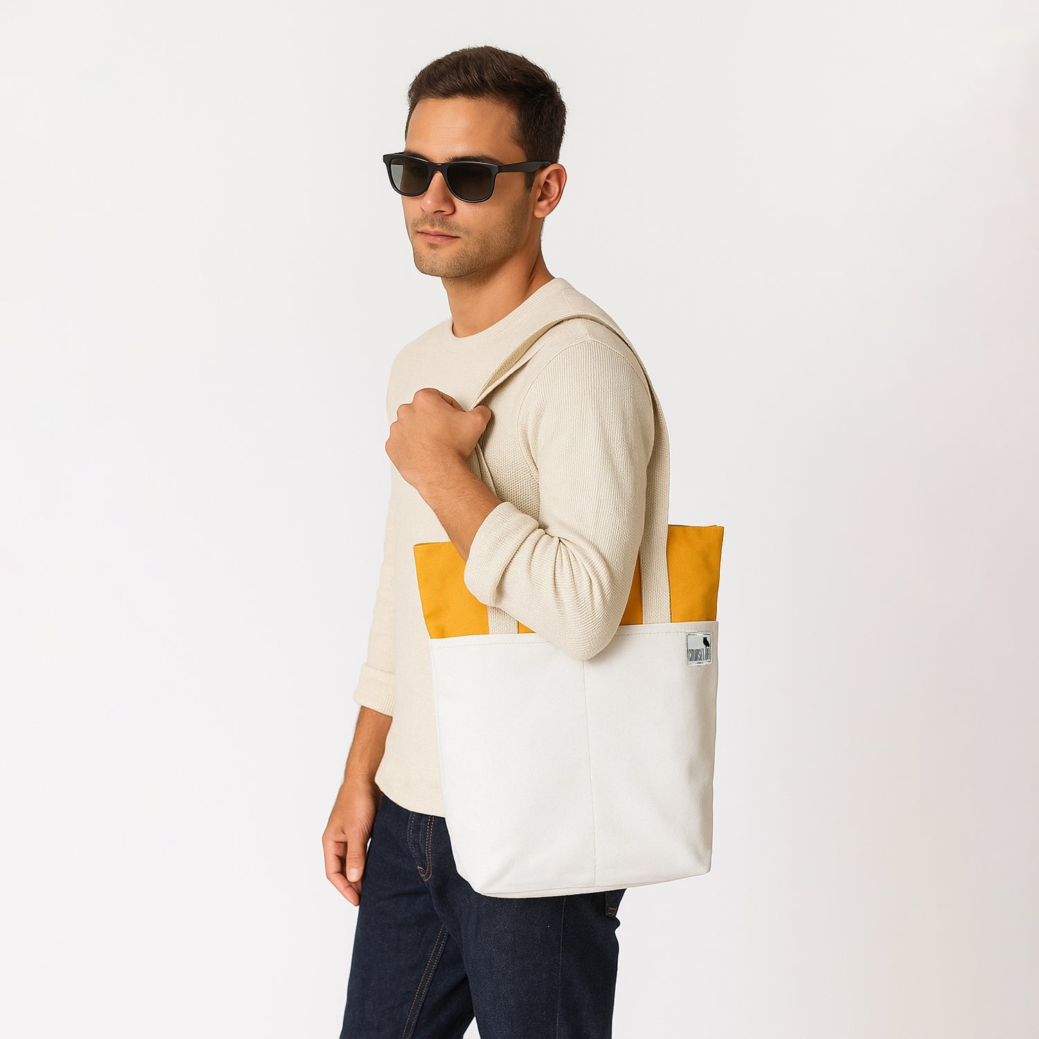 Stylish man wearing The Skylin offwhite and yellow tote bag, perfect for modern everyday use and storage.