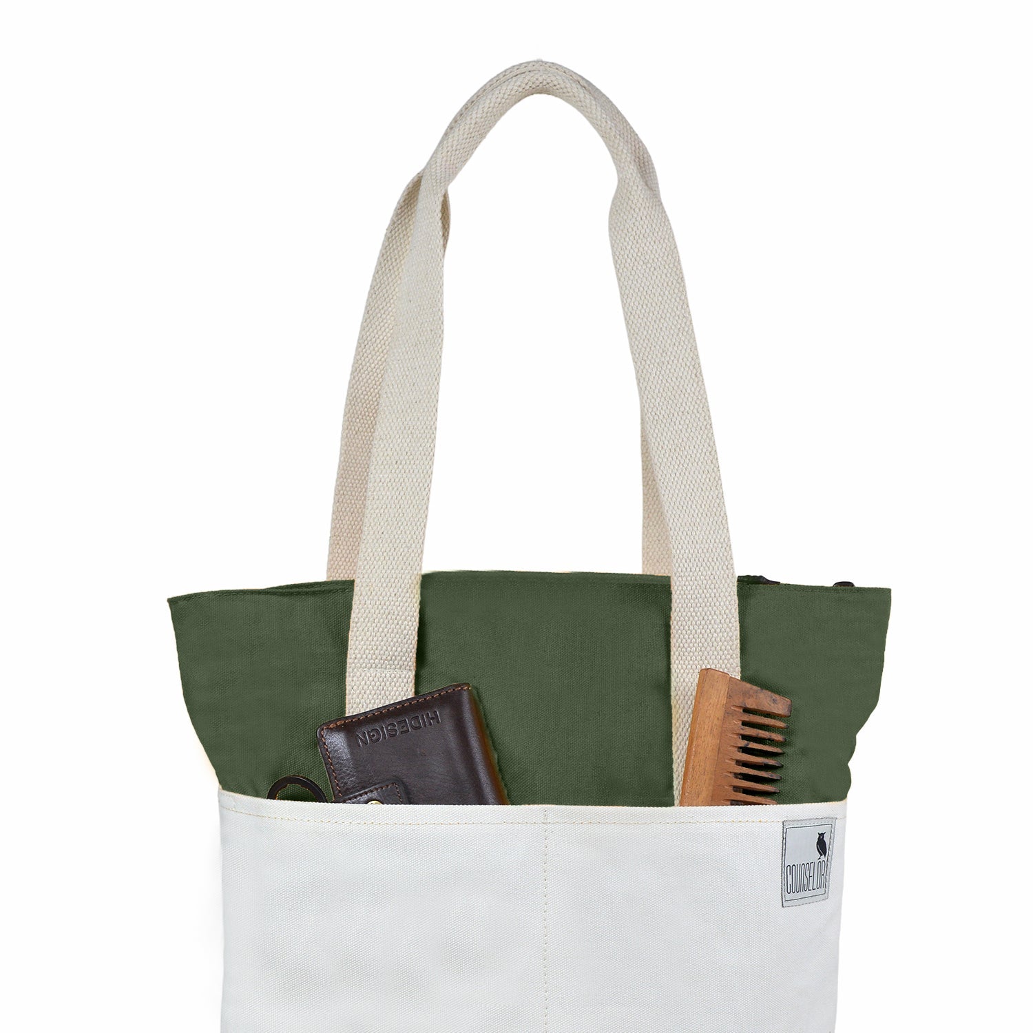 Offwhite and army green tote bag with organized items like a wallet and comb in front pocket.