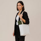 Model showcasing the Skylin tote bag in off-white and army green, wearing a stylish outfit.
