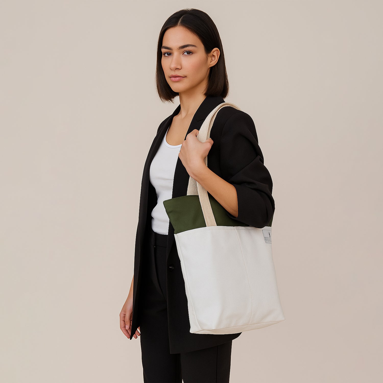 Model showcasing the Skylin tote bag in off-white and army green, wearing a stylish outfit.