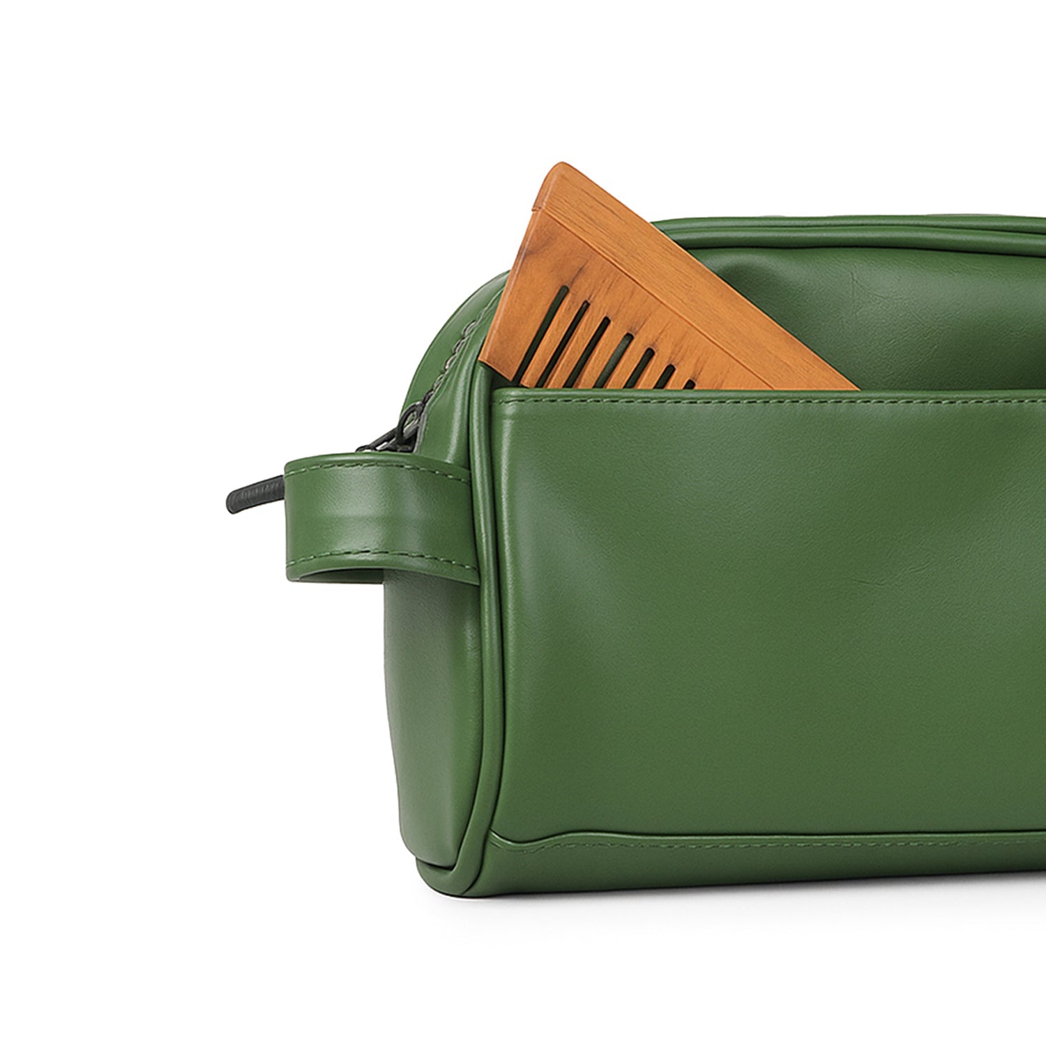 Green vegan leather toiletry bag with wooden comb in pocket, showcasing chic and eco-friendly design.