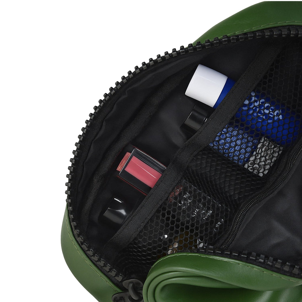 Interior view of The Swift Green Toiletry Kit showcasing organized travel essentials in mesh pockets.