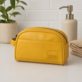 Chic mustard yellow toiletry kit made from eco-friendly vegan leather, perfect for travel organization.