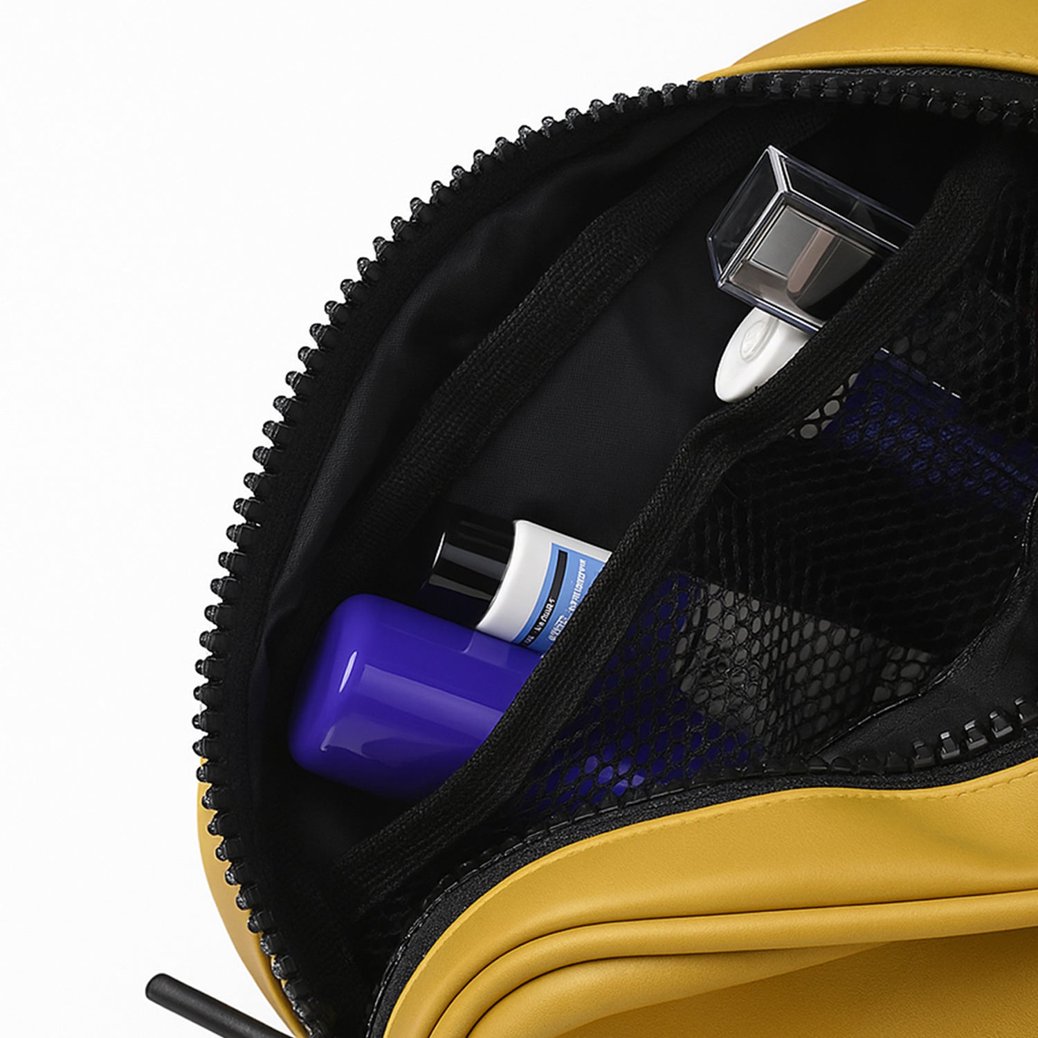 Interior view of the Swift Mustard Toiletry Kit with organized toiletries in vegan leather design.
