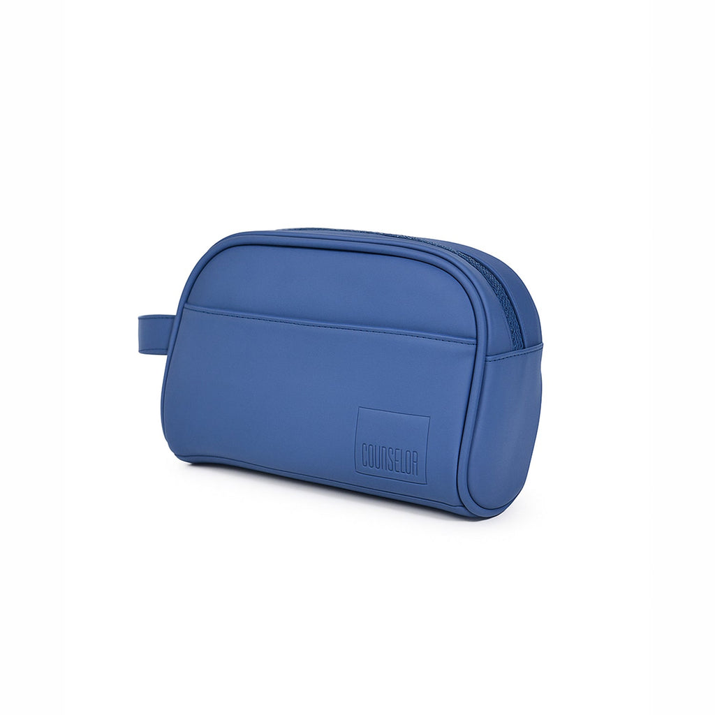 The Swift Toiletry Kit in navy, made from vegan leather, showcasing its sleek and travel-friendly design.