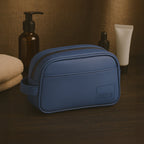 Chic navy toiletry kit made from vegan leather, featuring a zippered closure and durable design, ideal for travel and daily use.