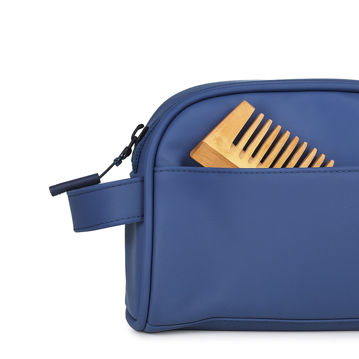 Navy toiletry kit featuring a wooden comb peeking out of the front pocket, showcasing chic eco-friendly design.