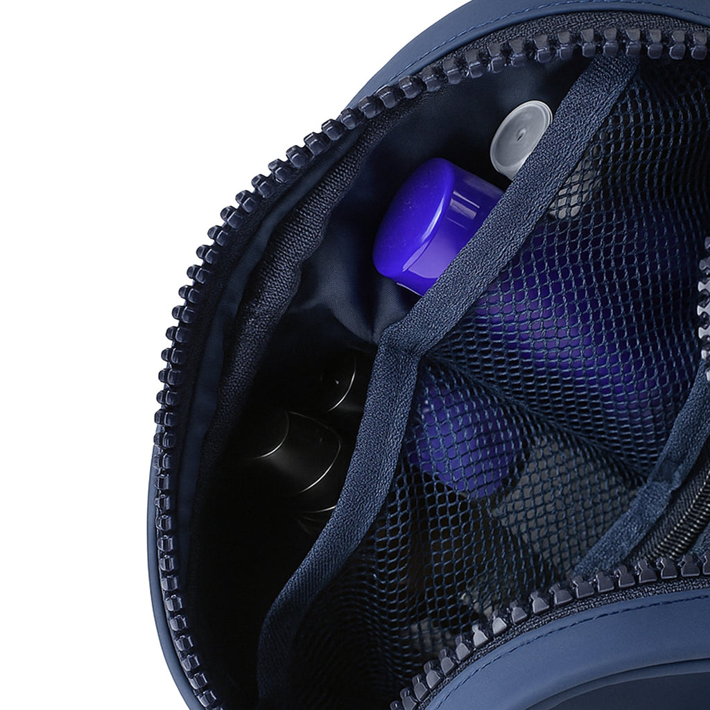 Interior view of The Swift Navy Toiletry Kit showing organized compartments and mesh pockets for travel essentials.