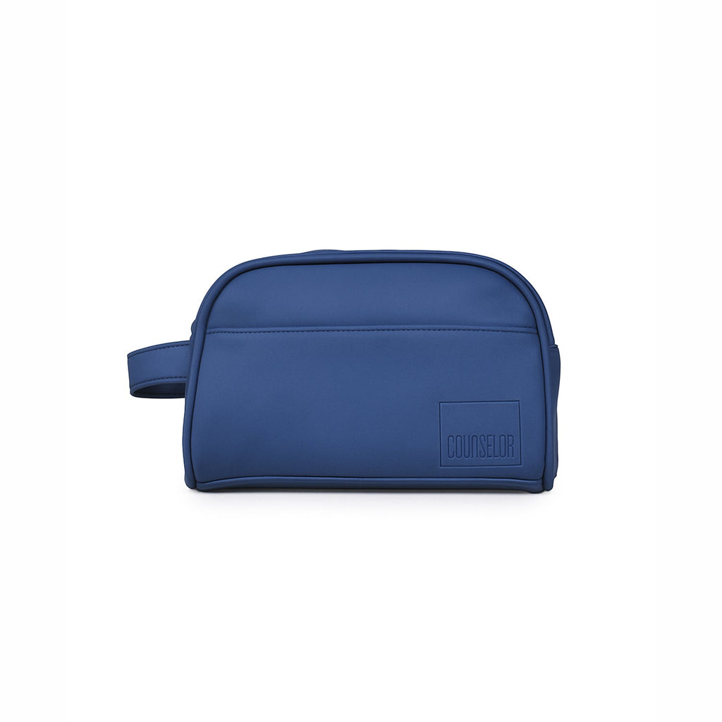 The Swift Toiletry Kit in navy, crafted from vegan leather with a spacious design for travel essentials.