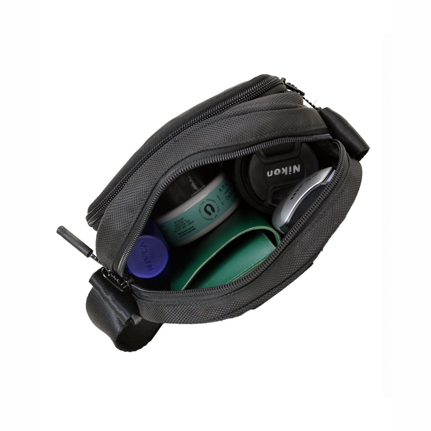 Inside view of the Luno black bag displaying organized compartments for essentials like jars and personal items.