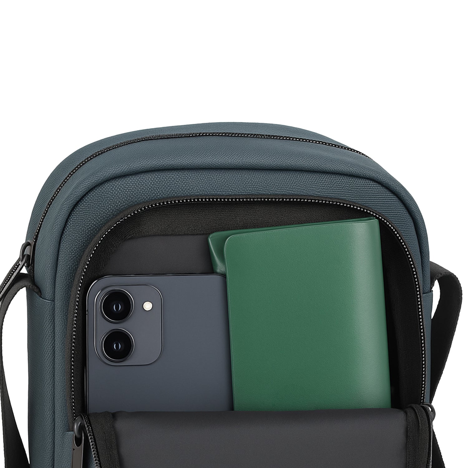 The Luno Grey bag with a smartphone and notebook visible inside, showcasing its smart organization features.
