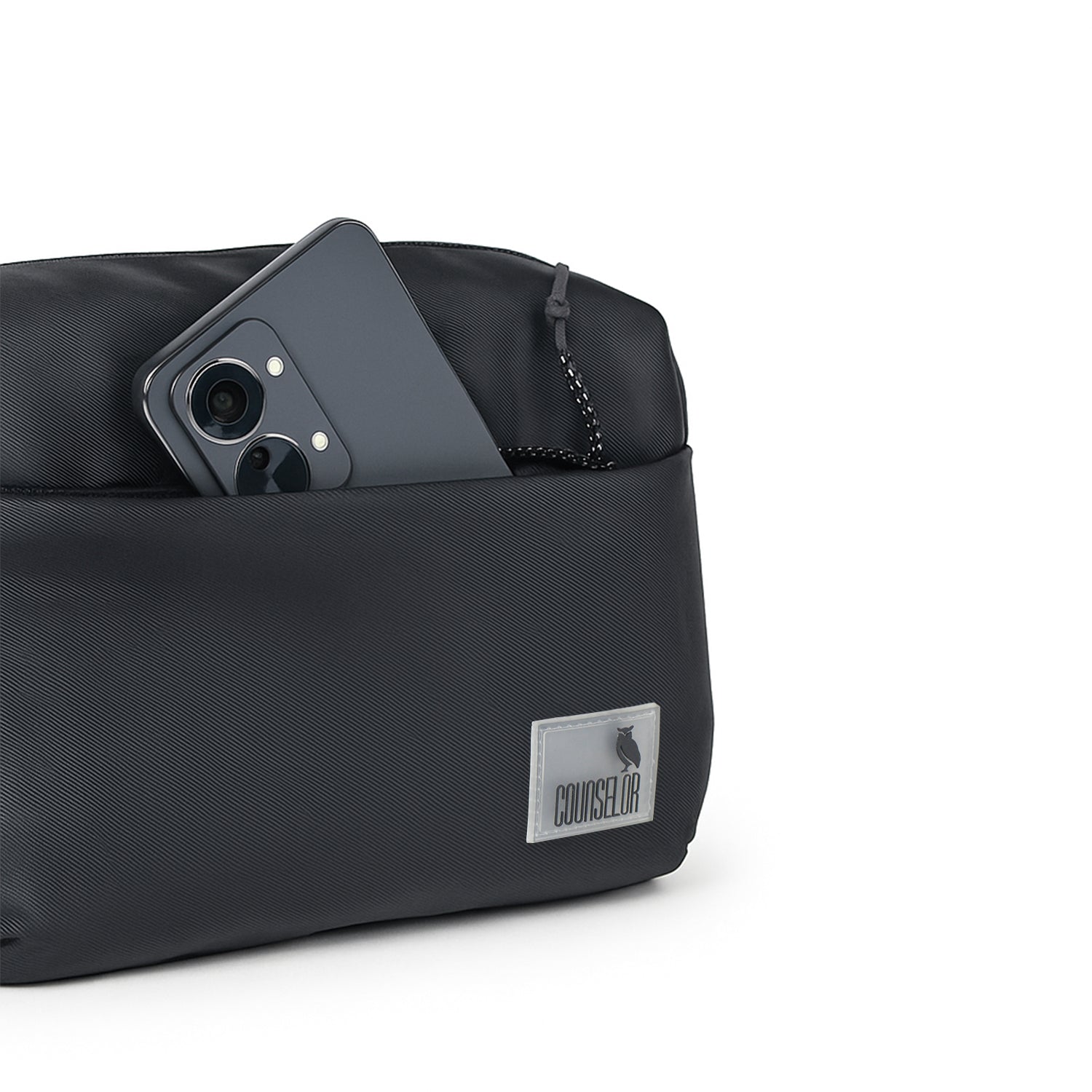 The Avelin black waistpack with smartphone in front pocket, showcasing minimalist design for everyday use.