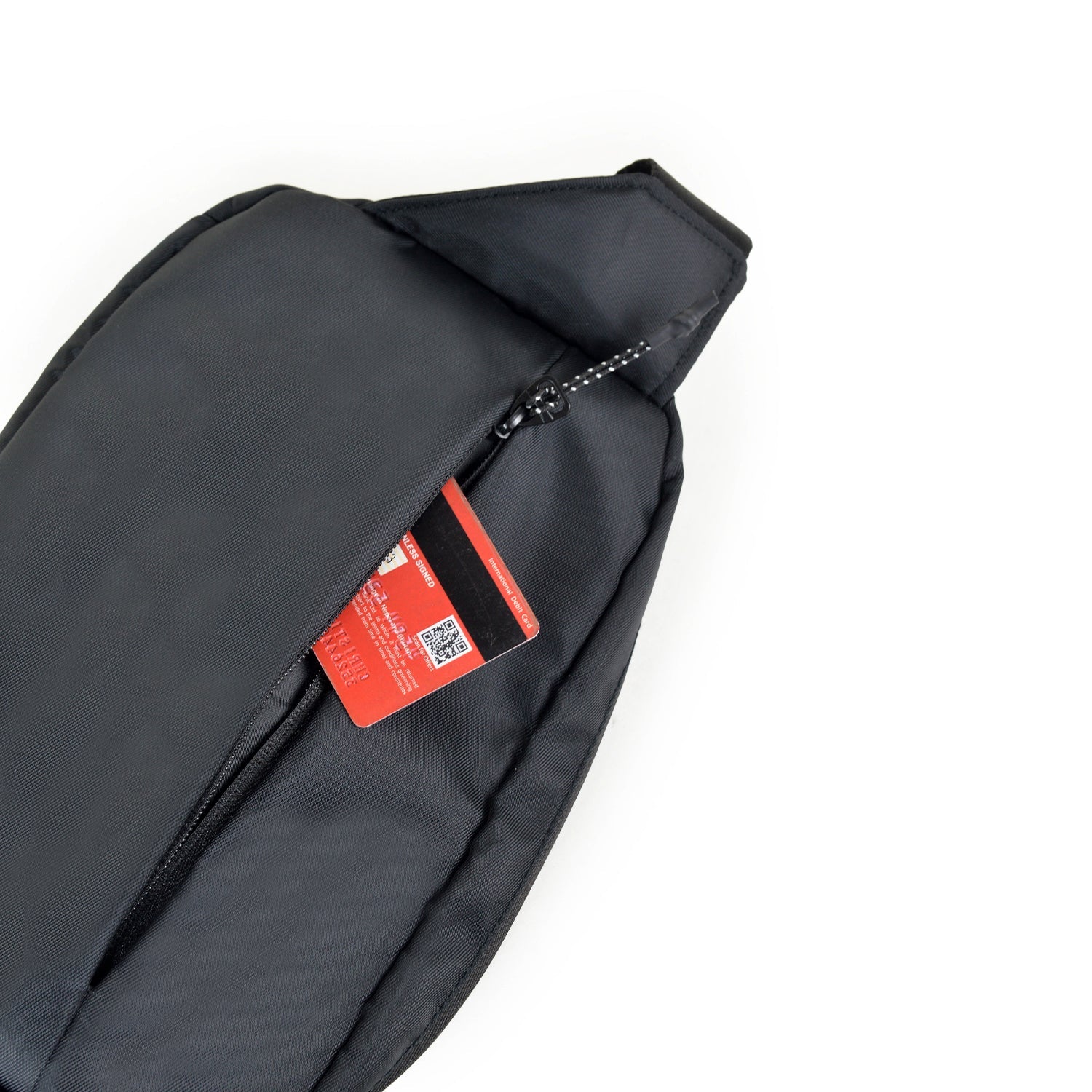 Close-up of the Avelin waistpack showing a secure zipper pocket with a card inside, perfect for everyday essentials.