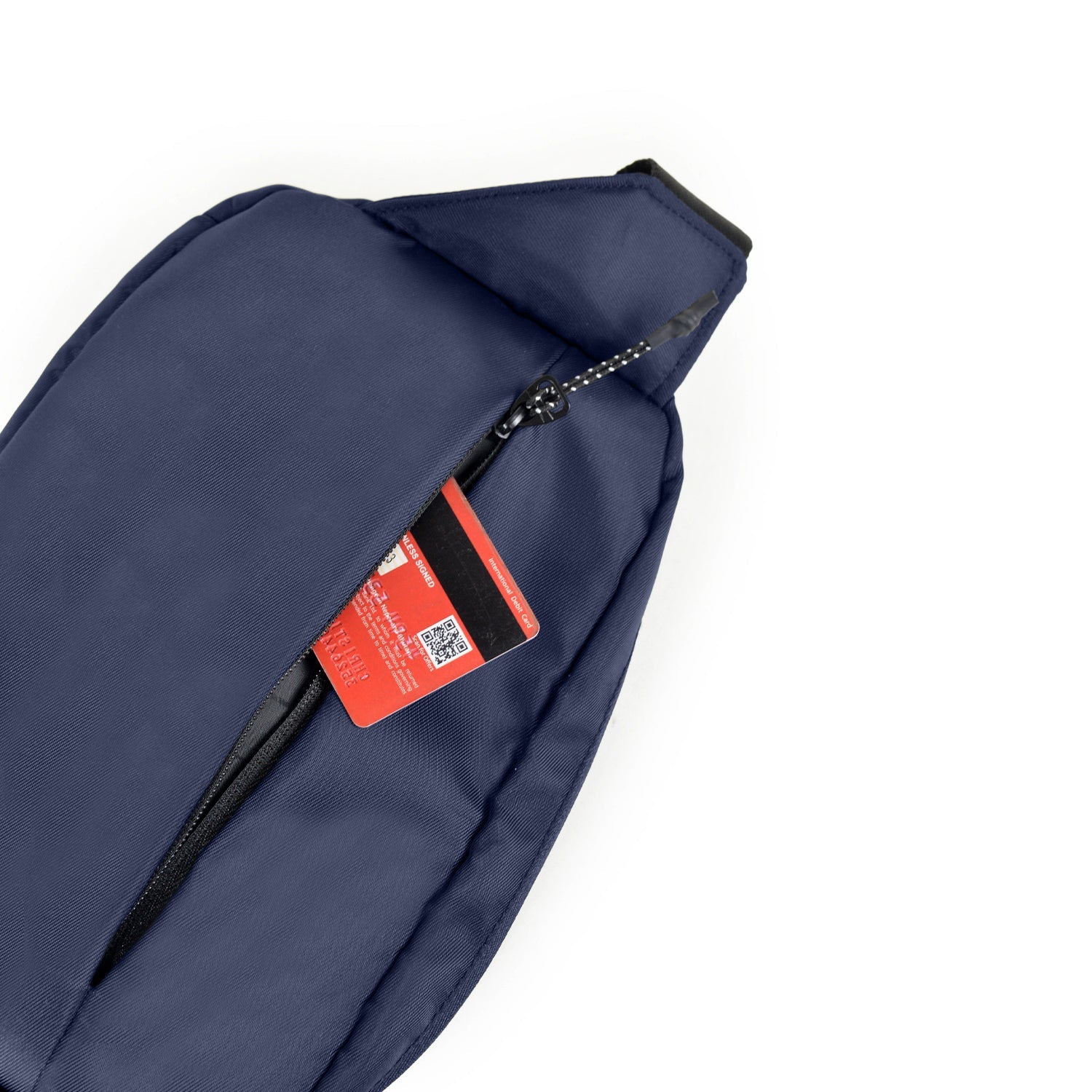 Interior view of The Avelin navy waistpack showing storage space with card and zippered pocket.