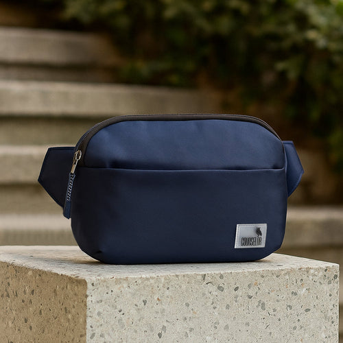 The Avelin navy waistpack is a minimalist, lightweight companion for easy city travel and smart storage.
