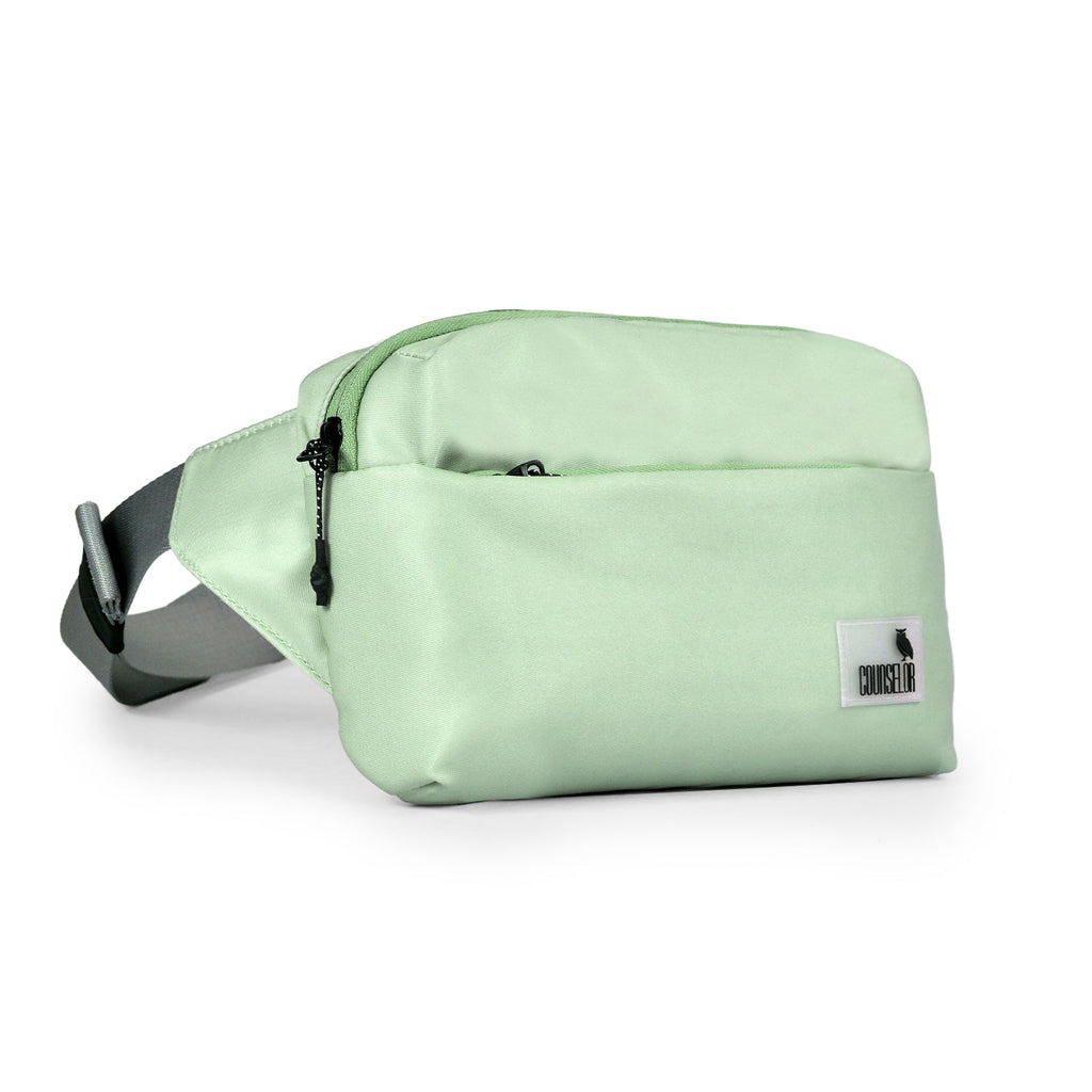 The Avelin waistpack in pista green, a minimalist, compact bag for everyday essentials, styled for comfort and versatility.