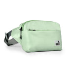 The Avelin waistpack in pista green, a minimalist, compact bag for everyday essentials, styled for comfort and versatility.