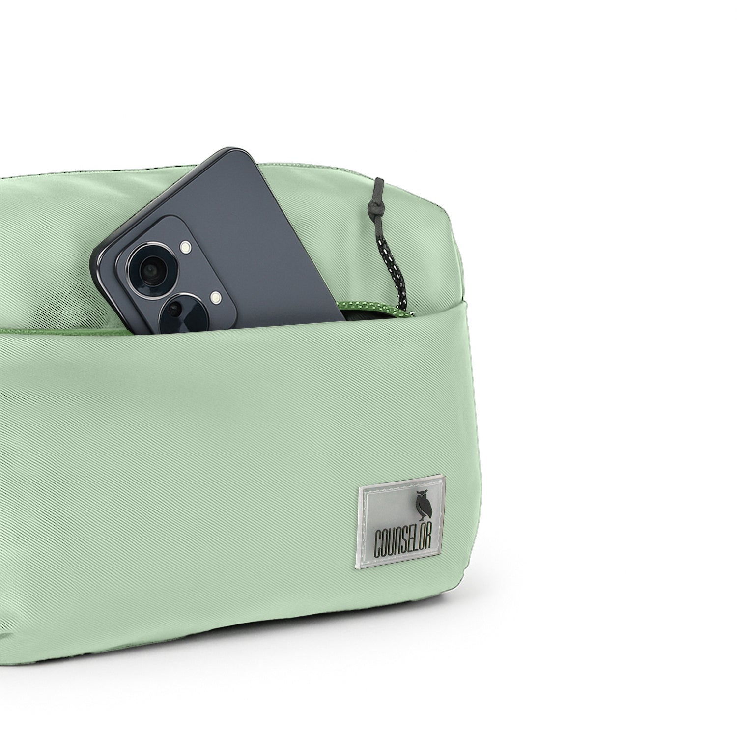 The Avelin waistpack in pista green, showcasing smart storage with a phone in the front pocket.