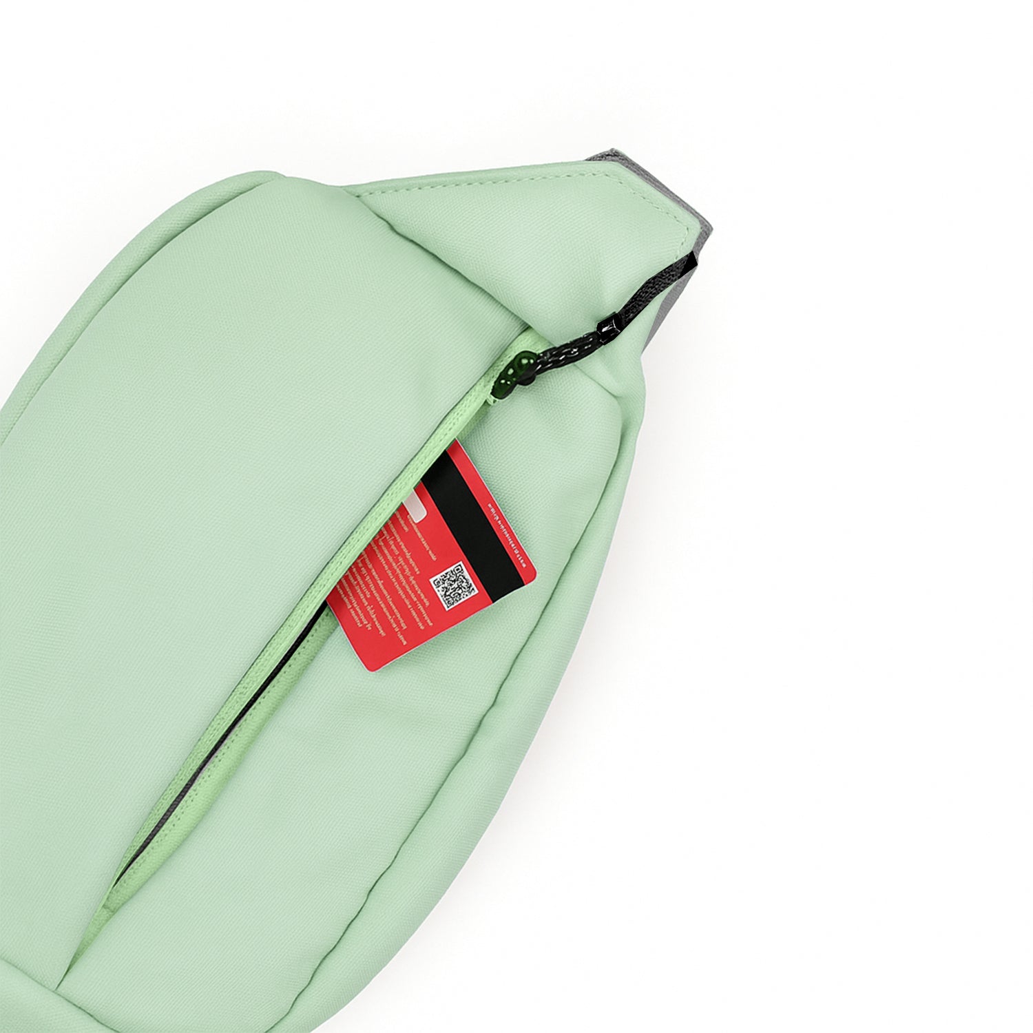 Close-up of the Avelin waistpack in pista green showcasing a front zipper pocket with a card inside.