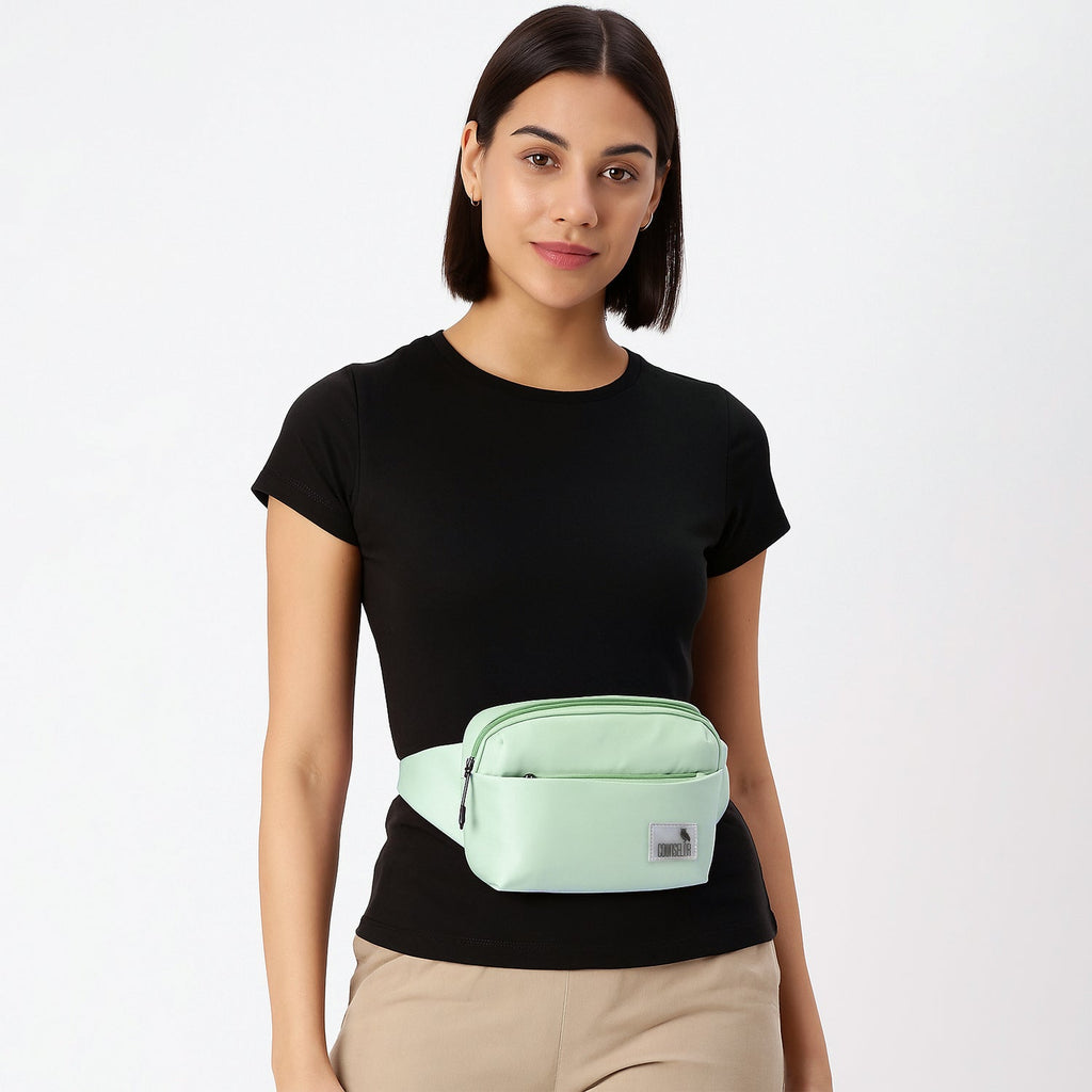 Model wearing The Avelin pista green waistpack, showcasing its minimalist design and smart storage for daily essentials.