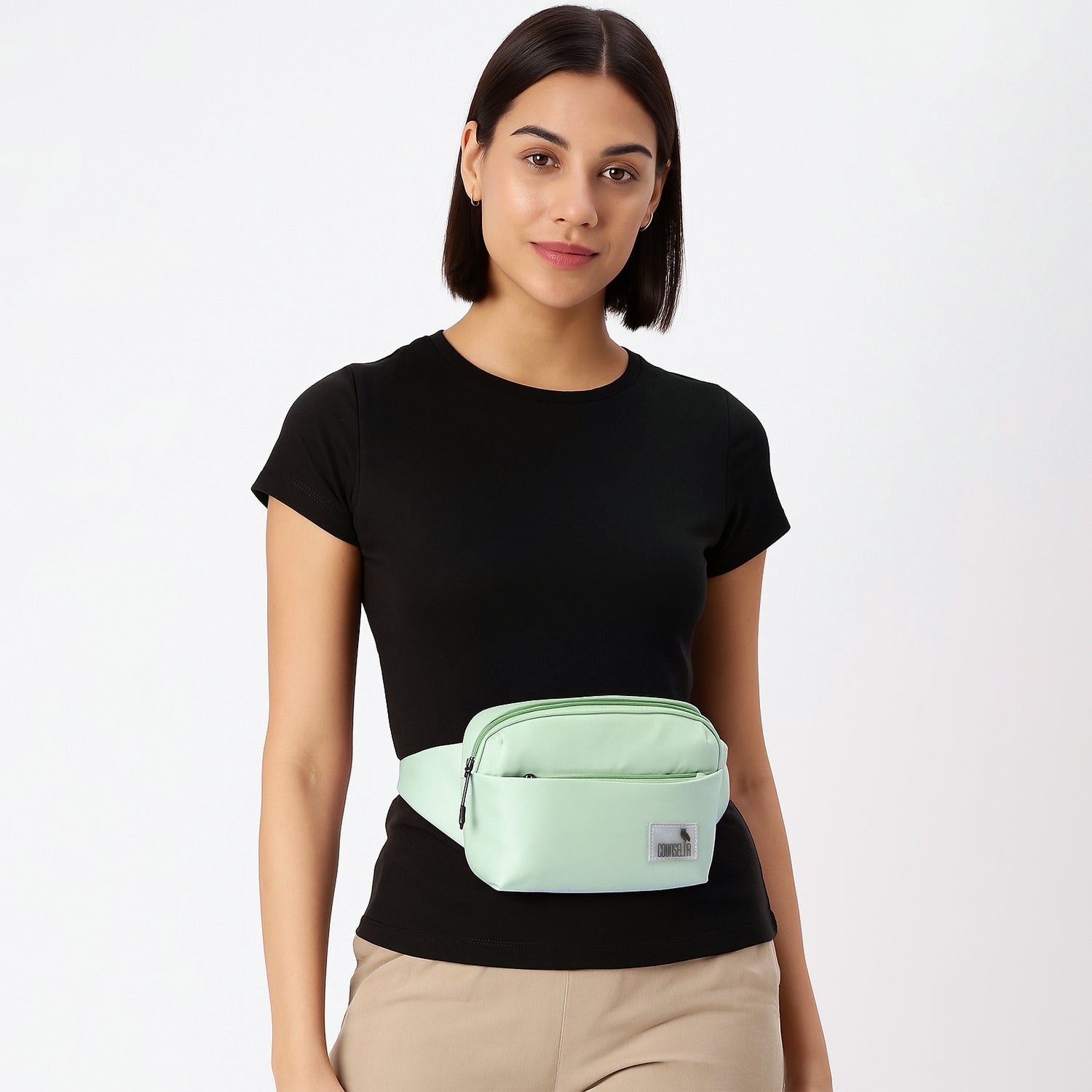 Model wearing The Avelin pista green waistpack, showcasing its minimalist design and smart storage for daily essentials.