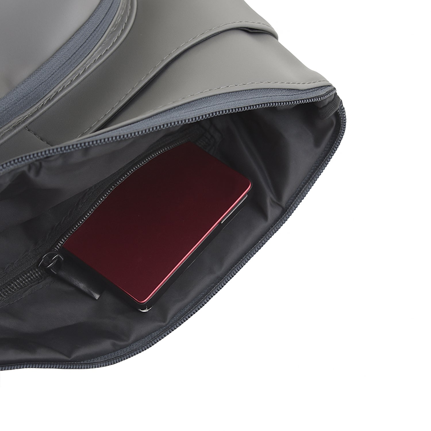 Interior of The Eiko grey pouch showing compact storage with a phone and zippered pocket.