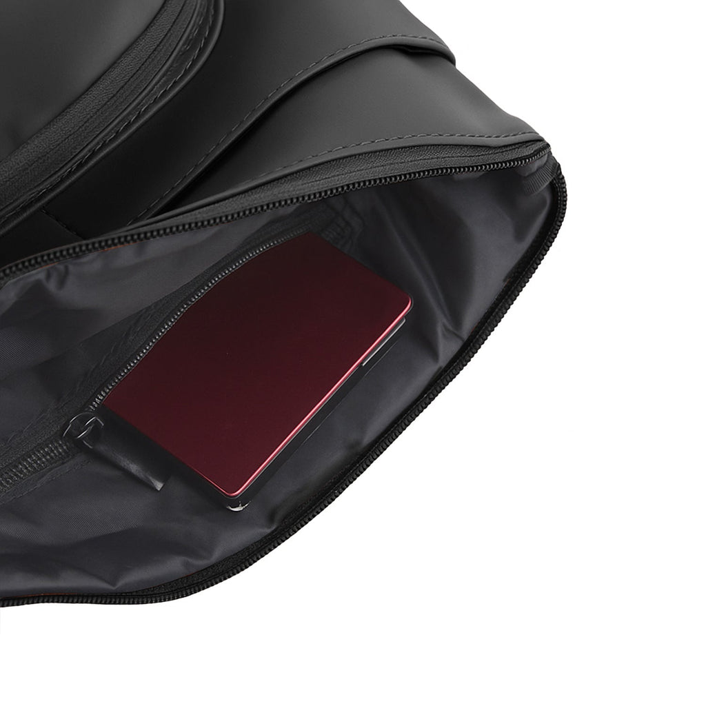 Interior view of The Eiko pouch showing compact storage with a phone and wallet.
