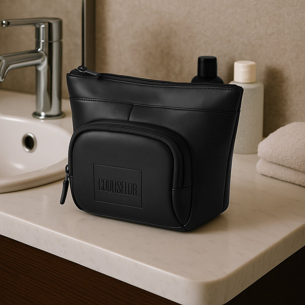 The Eiko black pouch displayed on a bathroom counter, showcasing its minimalist design and compact storage.
