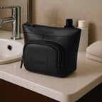 The Eiko black pouch displayed on a bathroom counter, showcasing its minimalist design and compact storage.