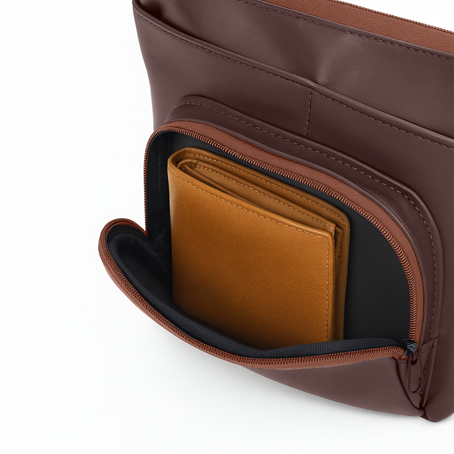 Interior view of The Eiko brown pouch showing compact storage with wallet in zippered pocket.