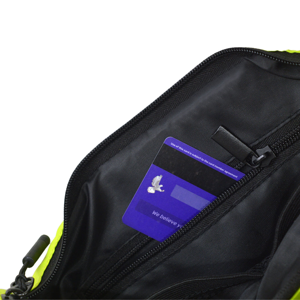 Interior view of the Zuki lime green sling bag showing an organized pocket with a credit card.