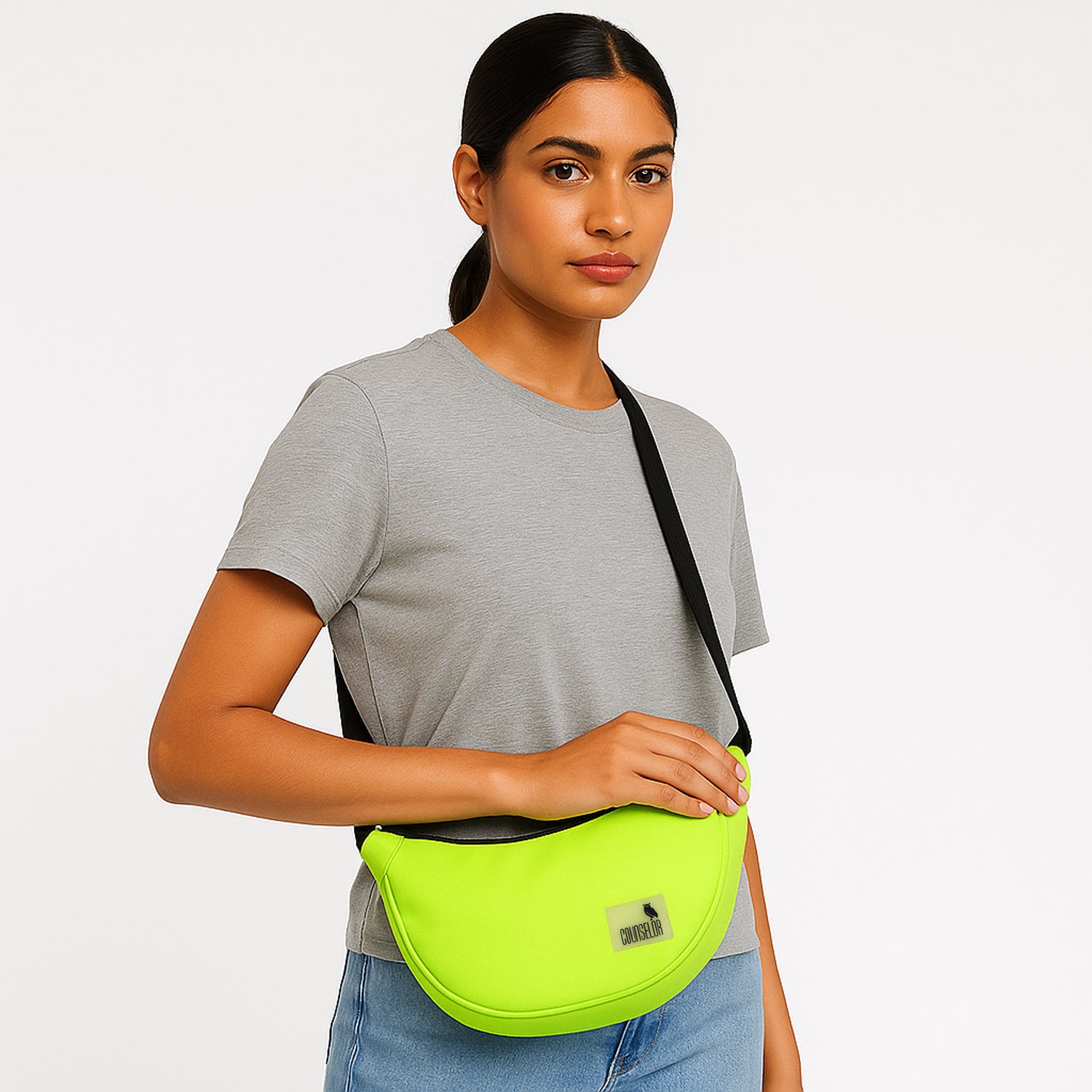 Woman wearing The Zuki Lime Green side sling bag, showcasing its sleek design and adjustable strap.