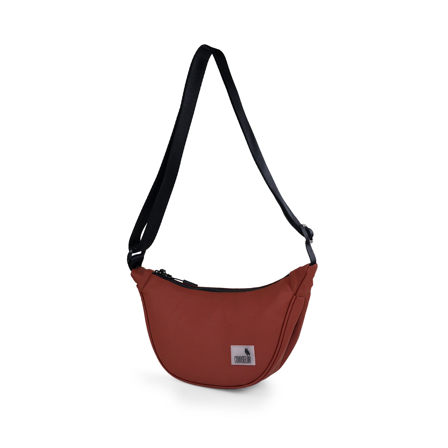 The Zuki side sling bag in rust color, featuring an adjustable strap and sleek design for daily use.