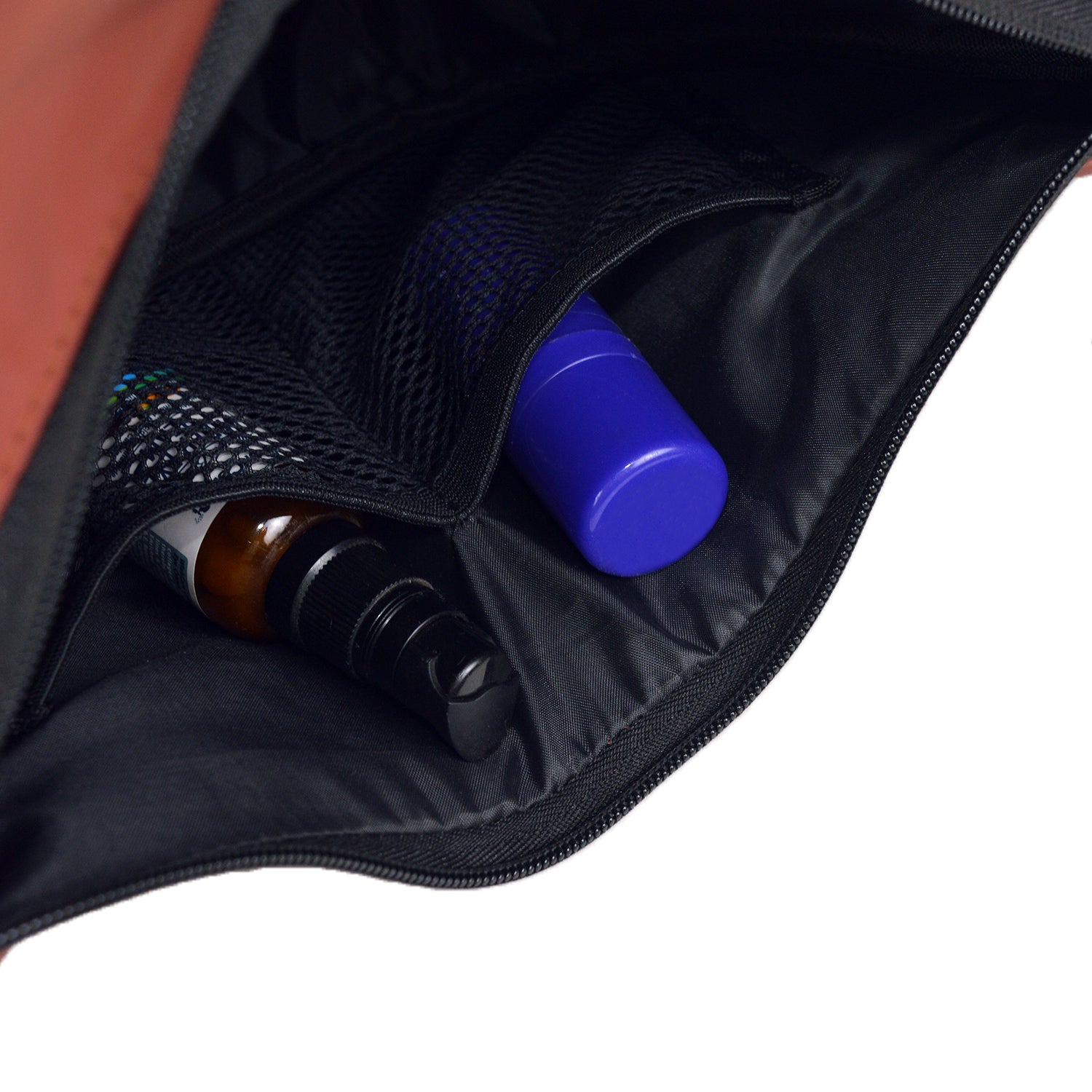 Interior view of The Zuki side sling bag showing organized storage for bottles and personal items.