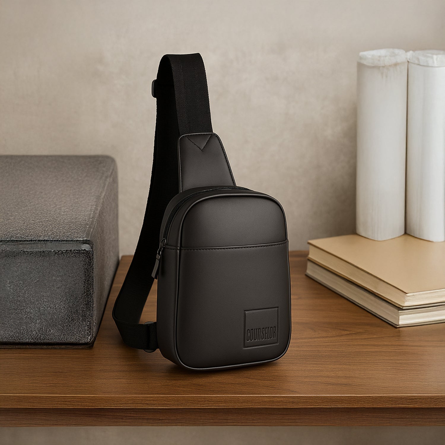 Stylish eco-friendly Kiro Crossbody Bag in black, showcasing durable vegan leather on a wooden surface.