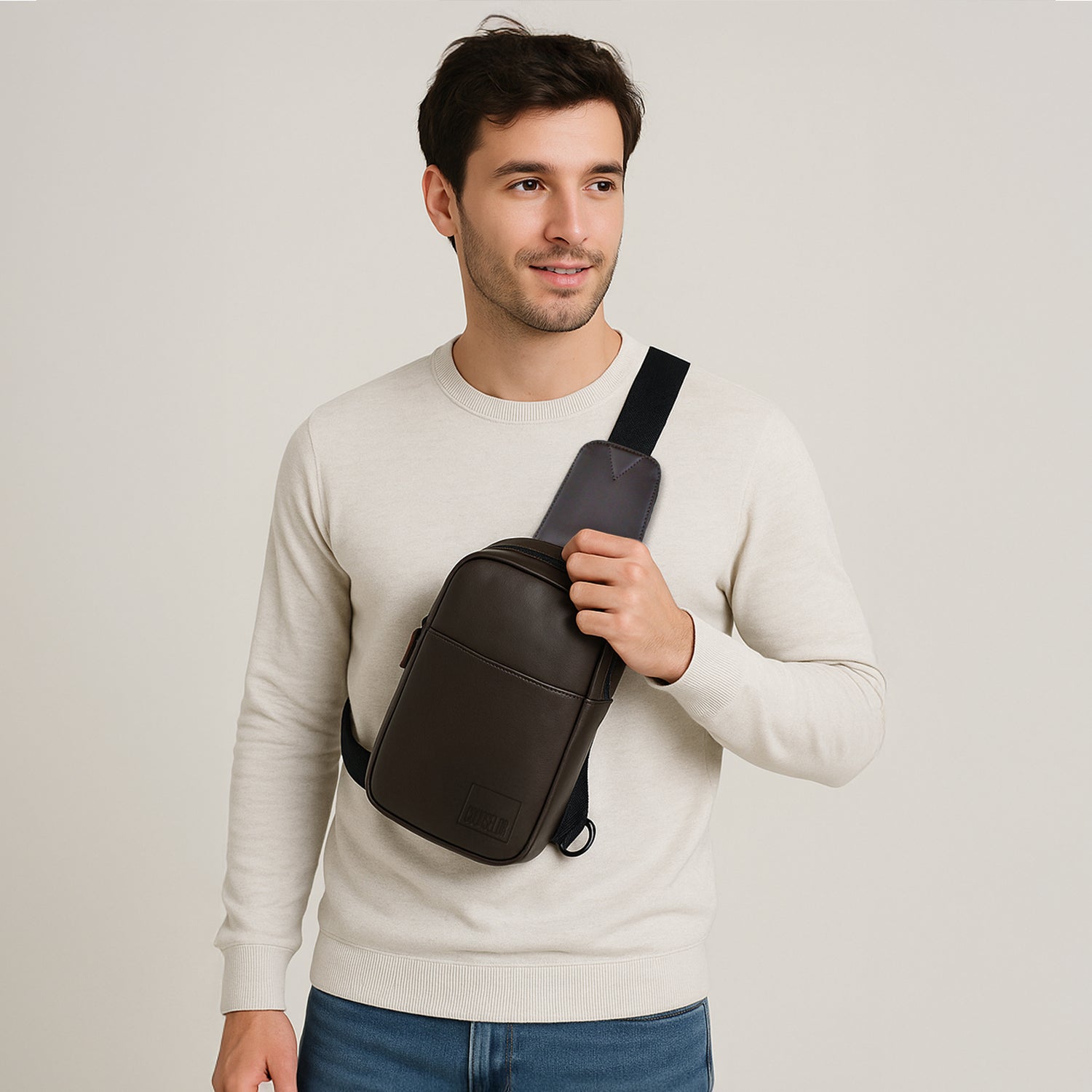 Man wearing the Kiro Crossbody Bag in brown, showcasing its stylish design and practical use.