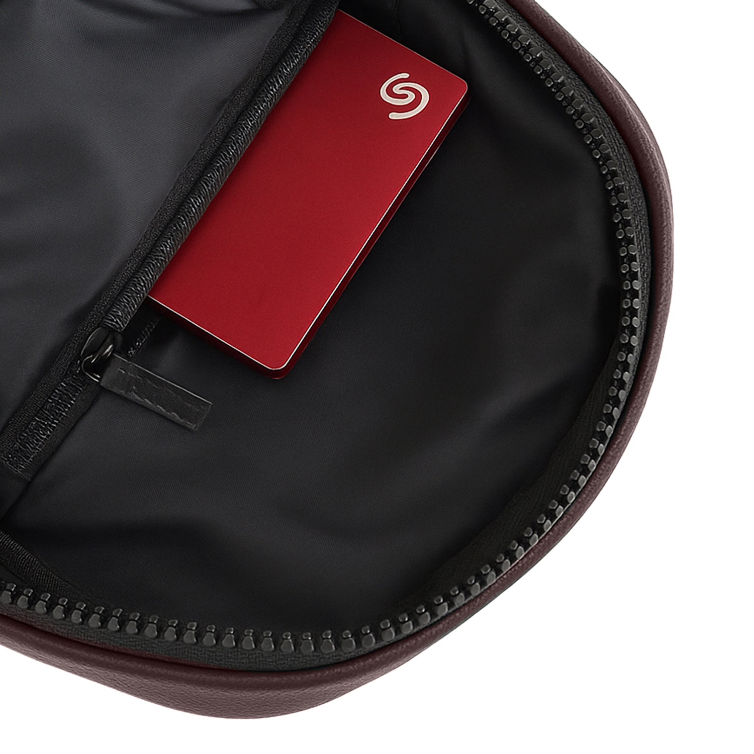 Interior view of the Kiro Crossbody Bag showing a zippered pocket with a card tucked inside.