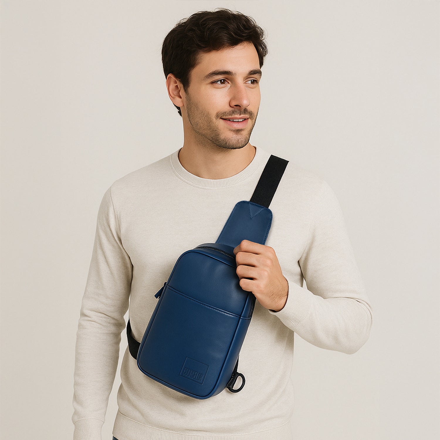 Man wearing the Kiro Navy Crossbody Bag, showcasing its stylish design and adjustable strap.